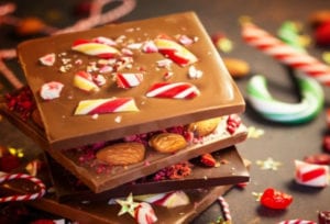 a stack of chocolate bars with candy canes
